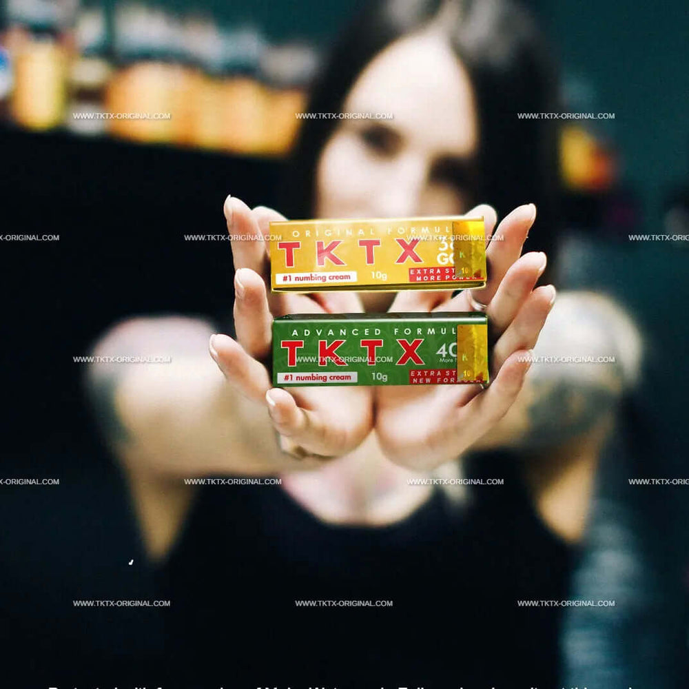 
                      
                        TKTX numbing tattoo cream displayed by person in tattoo studio
                      
                    